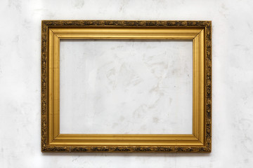 old gold frame on white wall.