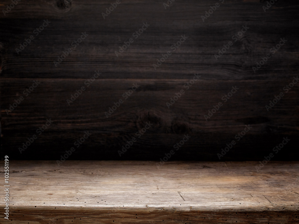 wooden table and dark wooden wall - obrazy, fototapety, plakaty 