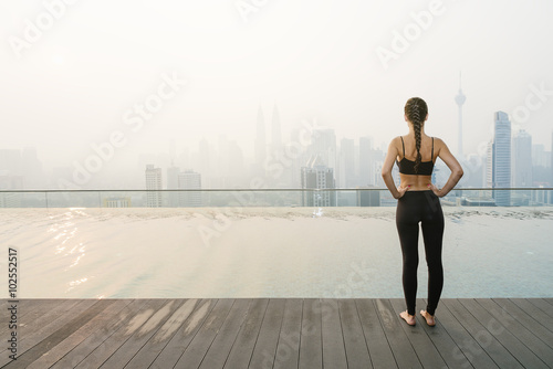 Fotografia, Obraz Relaxed young yoga woman in yoga pose near pool.
