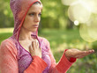 © AYAimages - Serene and peaceful woman practicing mindful awareness by meditating in nature at sunset with background bokeh.