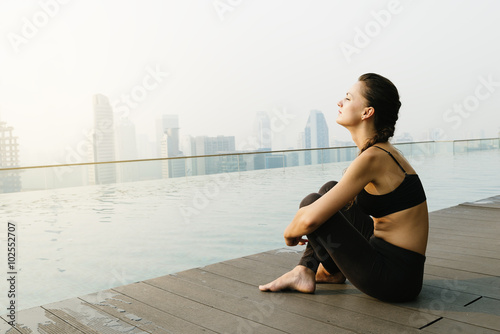 Obraz na plátne Relaxed young yoga woman in yoga pose near pool.