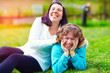 portrait of happy women with disability on spring lawn