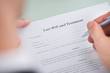 Person Hand Over Last Will And Testament Form
