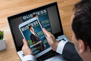 Poster - Businessman Reading Business Magazine On Tablet