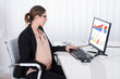 Pregnant Businesswoman Looking At Financial Graphs
