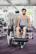 © WavebreakMediaMicro - Focused man using weights machine for legs