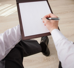 Unrecognizable businessman signing a contract