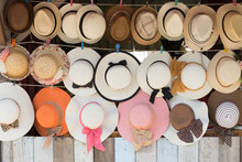 Straw Hats For Sale, Hanging On A Wall..