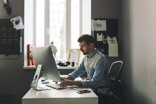 Young graphic designer working in office