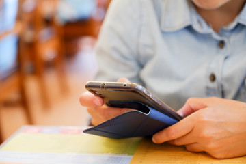 close up woman using mobile phone at restaurant, digital lifesty