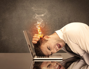 Sad business person's head catching fire