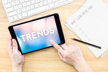 Poster - Finger touch screen with Trends word with keyboard and paper on