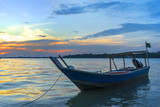 Fototapeta Zachód słońca - Wooden fisherman boat with sunset background