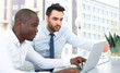 © ty - Image of two young businessmen interacting at meeting in office