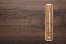 Wooden Thermometer On The Brown Table Background