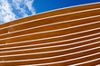 Detail of Modern Wooden Architecture / Close up of a modern wooden architecture on a blue sky with clouds