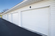 Row of garage doors at parking area for apartment homes