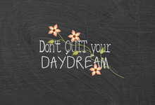 Daydream Quote With Flowers On Dusty Black Chalkboard