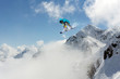 © Vasily Merkushev - Flying snowboarder on mountains. Extreme sport.