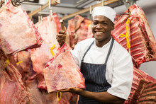 African Butcher Handing Beef In Slaughterhouse