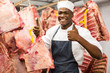african butcher holding meat