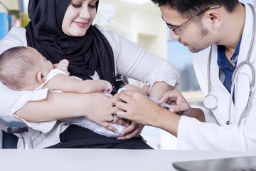 Poster - Pediatrician giving vaccine to baby boy