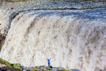 Sticker -   Elderly woman admires the picturesque waterfall