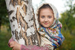 beautiful girl in a scarf in a tree in the park