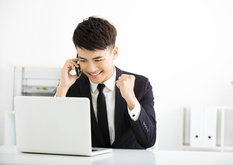 Wall Mural - happy young  businessman working in office