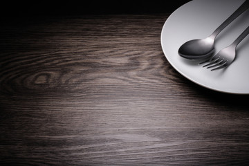 a set of cutlery on wooden background