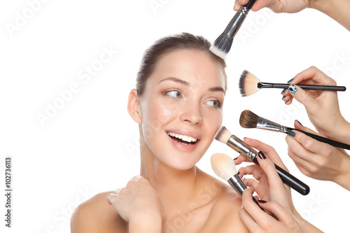 Fotografie, Obraz Closeup portrait picture of beautiful woman with brushes