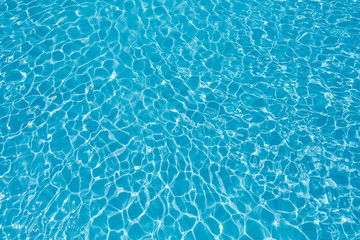 clean and bright water in swimming pool with sun reflection
