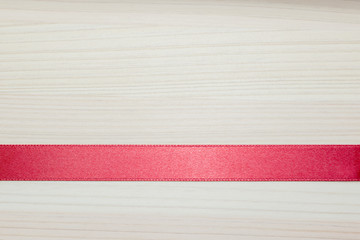 red ribbon or red strip on the wooden background