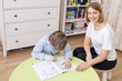 © Dimitriy - Beautiful young teacher looking at the camera and smiling.