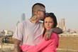 © Dog Paw Productions - Young Couple embracing against Dallas Texas skyline