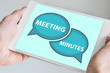 Meeting minutes concept with hands holding modern tablet or smartphone to be used as slide background
