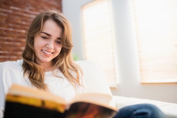 Smiling woman reading a book