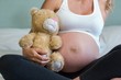 © WavebreakmediaMicro - Pregnant woman sitting with a teddy bear