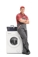 Poster - Young repairman leaning on a washing machine