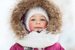 face of happy little kid or girl in winter clothes