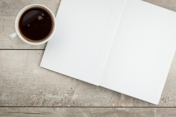 Photo blank. Open book, brochure on a wooden table and coffee