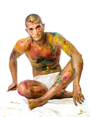 Handsome young man with skin all painted with Holi colors