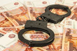 the handcuffs on the background of Russian rubles