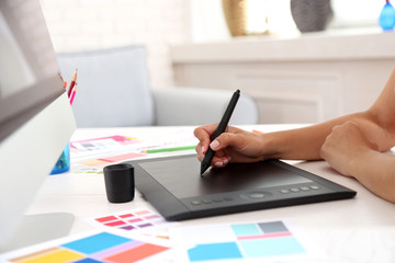 Artist drawing on graphic tablet in office