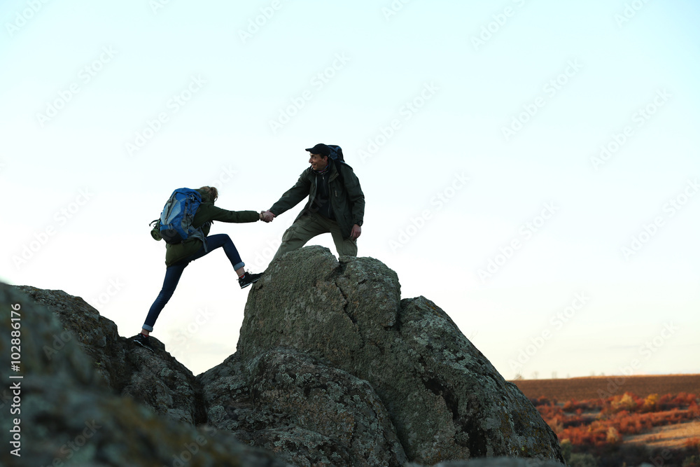 Man and woman climbing the mountain