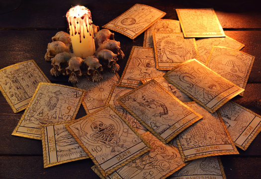 pile of the tarot cards in candle light