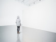 © SFIO CRACHO - Photo of girl in modern gallery looking at the blank canvas.