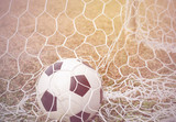 Fototapeta Sport - Football in goal.Process in vintage color tone