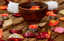 Spa Composition With Rose Petals And Candle In Clay Bowl