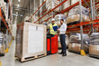 worker on forklift and businessman at warehouse
